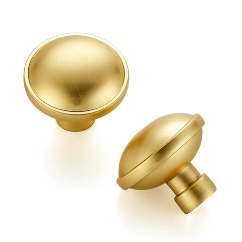 Rock Solid Zinc Alloy Cabinet Pulls Featuring A Slick Brushed Gold Finish 1 1/4 Inch Diameter heavy duty knobs shown from an angle.