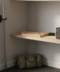 Teal Barbell Plate Lifter Deadlift Jack on shelf, wooden EVA structure visible, gym storage scene