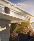 Person installing SoloCam S340 4 Cam Kit With HomeBase S380 Solar Powered Wireless Outdoor Cameras under roof eave.