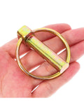Hand holding one of the Eight-Piece O Shape Pin Heavy Duty Trailer Hitch Pin Kit 7/16 Inch By 1-3/4 Inch Pins for trucks and machinery