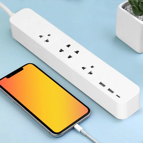 Smart Power Strip With WiFi And Bluetooth Remote Access, Voice Activated Outlets, Quick Charge USB And Type C Ports, App Managed Surge Blocker on a blue surface with a smartphone charging.