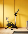 Get Your Gym Session Rocking With 4 Heavy Duty Pull Pin Springs For Exercise Bikes And Training Gear, Sturdy Iron And Abs Steel Height Adjust Locks That Are Easy To Install And Built To Last A Long Time. Exercise bike in a bright yellow room with a tension knob.