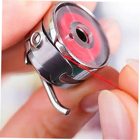 Close-up of Two Piece Bobbin Case Set For Sewing Machines, Handy Replacement For Old Or Broken Cases shown with red thread