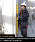 48 Inch Heavy Duty Aluminum Spirit Level Featuring Dead On Accuracy A Slick Aluminum Body And Leak Free Vials For Smooth Layout Work held by a worker.