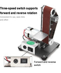 Mini electric belt sander with three-speed switch for forward and reverse rotation, designed for precision sanding and polishing.