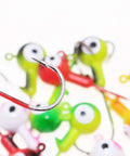 Top Shelf Ball Head Jig Heads Set With Razor Sharp High Carbon Steel Hooks For Freshwater Saltwater Fishing 1 32oz To 1 2oz Assorted Two Tone 50 Piece Pack Strike Hard Catcher close up of shiny hook with colorful jigs in background