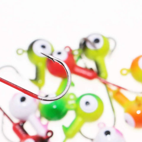 Top Shelf Ball Head Jig Heads Set With Razor Sharp High Carbon Steel Hooks For Freshwater Saltwater Fishing 1 32oz To 1 2oz Assorted Two Tone 50 Piece Pack Strike Hard Catcher close up of shiny hook with colorful jigs in background