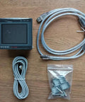 All In One PLC HMI with 2.8 inch touch screen display, seven input five relay outputs, four transistor outputs for 100KHz, FX1S compatible unit with cables and mounting hardware on wood surface.