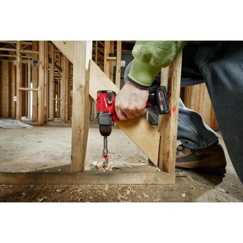 Person using Built Dang Tough 12 Volt Cordless Drill And Driver with brushless motor to drill into wood at a construction site.