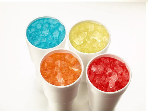 Four cups filled with colorful nugget ice, showcasing various flavors for refreshing drinks, featuring smooth texture.