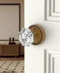 Close-up of 6 Pack Privacy Antique Brass Crystal Door Knobs With Lock For Bedroom Or Bathroom installed on white door