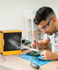Pro Grade Solder Fume Extractor for Soldering Stations and DIY Projects in use, absorbing smoke, electronics workspace
