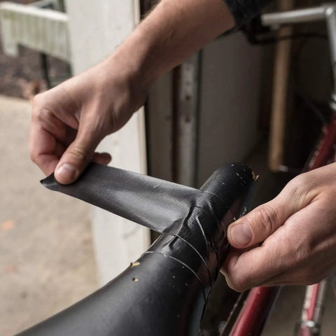 Applying Max Strength Duct Tape Heavy Duty All Weather Waterproof Bond One Roll 1.88 Inch By 35 Yards Black on bicycle seat