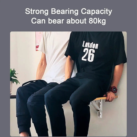 Two people sitting on a wooden shelf attached with Heavy Duty Folding Shelf Brackets Built Legit Durable With Seamless Stainless Steel Wall Mount Table Support Hardware For Space Savvy DIY Setups And Collapsible Floating Shelves.