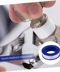 Close-up of 30 Pieces PTFE Thread Seal Tape DIY Leak Repair High Density Plumbing Fittings applied on metallic pipe connection.