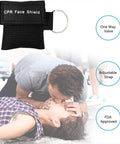 Front view of Yzpacc CPR face shield set, 50-pack in black fabric pouch with key ring and one-way valve