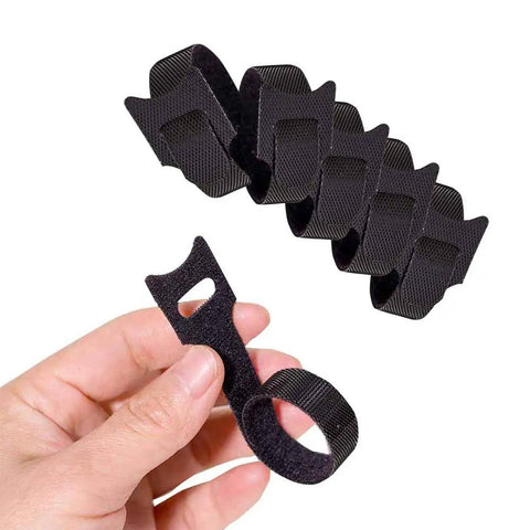 Hand holding black Six Inch Reusable Fabric Cable Ties With Hook And Loop 100 Pack Multi Color Cable Organizer Straps For Cord Management