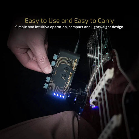 Hand holding USB Rechargeable Portable Pocket Guitar And Bass Headphone Amp with Plug In Multi Effects connected to guitar.