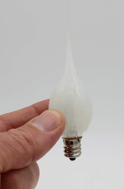 Warm 5 Watt Silicone Dipped Candle Lamp Bulb for Chandeliers Replacement held showing E12 candelabra base with rustic vibe