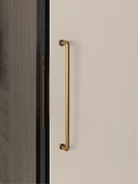 10 Inch Cabinet Bar Pulls With Antique Brass Finish 256mm Hole Centers Set Of 2 for cabinets, shown on a beige cupboard door.