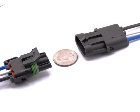 Two 3-pin waterproof electrical connectors with locking tabs, black housings, green gasket and blue/white wires.