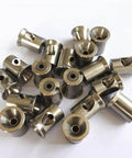 Set of stainless steel waterjet mixing chamber components, cylindrical fittings with central holes.
