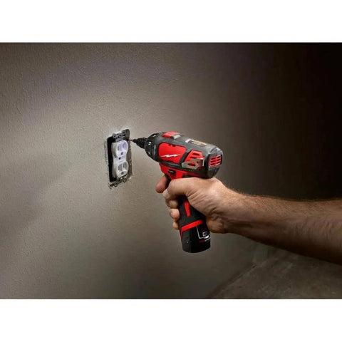 Hella Compact And Ridiculously Slick 12V Cordless Driver Drill Kit With Variable Speed Trigger in use on wall outlet.