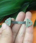 Close-up of antique brass zinc alloy mini jewelry box drawer cabinet pull handle from 10 pack, held in hand, vintage look, with 38mm hole spacing.