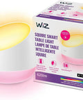 Squire Smart Table Lamp With Motion Activation And Color Changing LEDs shown lit next to its packaging box.