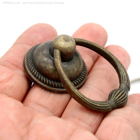 Set Of 6 Vintage Antique Brass Drop Ring Pulls For Drawers With Single Mounting Hole Large Ring Size 1.4-Inch And Pull Height 2.1-Inch Retro Style Drawer Handles - close-up view showing detailed design and finish on hand