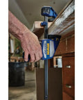 Heavy Duty One Hand Bar Clamp For Woodworking And Shop Fixes With Quick Toggle Spreader Mode and grippy pads in use on wood.