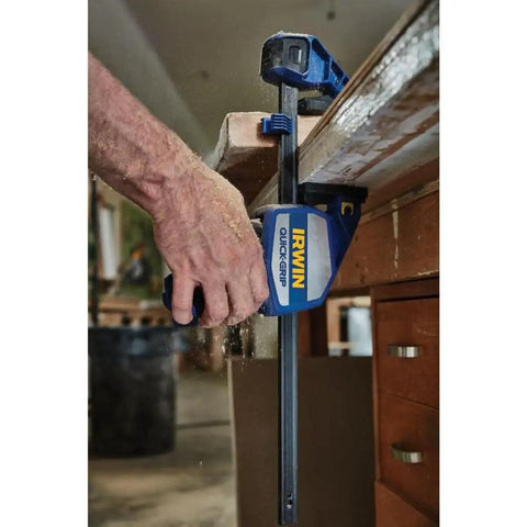 Heavy Duty One Hand Bar Clamp For Woodworking And Shop Fixes With Quick Toggle Spreader Mode and grippy pads in use on wood.