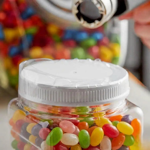 Clear Tamper Evident Heat Shrink Bands That Fit Snug And Lock Down Solid For 89Mm Caps With Max 3.5 Inch Diameter Non Perforated Safety Sealing For Jars Bottles And Containers on a jar lid with colorful jelly beans visible.