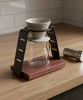 Straight Up Solid Coffee Stand And Dripper Holder Built With Heavy Duty Carbon Steel And Wooden Pedestal Base For Clean Manual Brew Organization That Stays Crisp on a wood countertop.