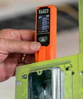 Person using Super Handy Laser Distance Measure That Runs From 2 Inches To 100 Feet With Sharp Precision Reads Feet Inches And Meters Backlit LCD