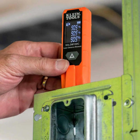 Person using Super Handy Laser Distance Measure That Runs From 2 Inches To 100 Feet With Sharp Precision Reads Feet Inches And Meters Backlit LCD