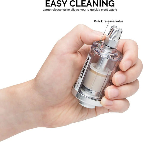 Hand holding the Water and Oil Separator For Air Lines Two Pack One Quarter Inch NPT Inlet And Outlet Air Tool Filter Dryer.
