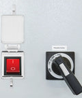 Dope Ship Type Rocker Switch Cover With Clear Flip Top Shield And Double Sided Adhesive on a wall panel, preventing accidental activation.