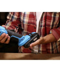 20V Lithium Ion Cordless Angle Grinder Built Like A Tank With An Adjustable Side Handle For Tough Cutting And Grinding Jobs Totally Wire Free So You Can Cruise Through Any Project Without Breaking A Sweat Or Dealing With Snags held in hand with a battery pack attached.