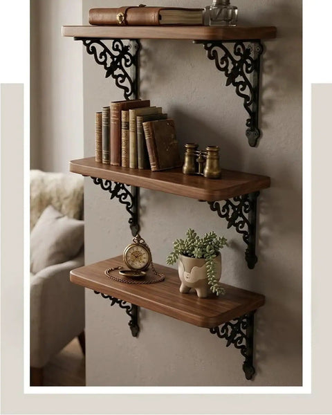 Slick Vintage Black Shelf Brackets Rock Solid Cast Iron L Brackets With Timeless European Scroll Detail supporting wooden shelves with books.