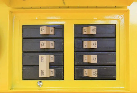Close-up of thermal breakers in a Pro Grade Job Site Power Distribution Workhorse with durable yellow exterior.