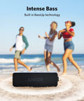 Beefy Bass Portable Bluetooth Speaker With Crisp Stereo Sound, IPX7 Waterproof, 24 Hour Playtime on beach with people dancing