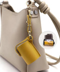 Compact Water Film Holder Case With Keychain Clip shown on a beige bag for on-the-go camera gear and outdoor shoots