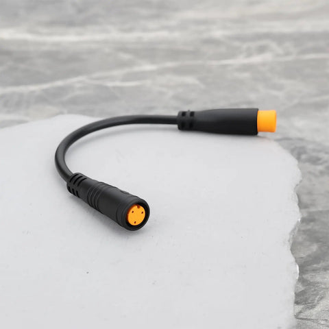 Close-up of black 3-pin waterproof sensor cable for e-bikes, male to female connectors. Product: Two Pack 3 Pin Electric Bicycle Sensor Cables Waterproof Male To Female Connectors For E Bikes Upgrade And Maintenance Compatible With Throttle Sensors Gear Sensors Thumb Throttles Rotary Throttles Brake Levers And Hydraulic Brake Sensors.