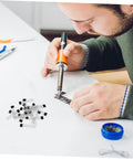 Person soldering components with soldering iron, showcasing Built Tough 20 Piece Hall Effect Sensor Kit With Bipolar Latching Linear Sensor For Heavy Duty Industrial Automation And Automotive Diagnostics Easy As Pie Dead Nuts Precise Magnetic Switches.
