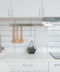 Modern kitchen with white cabinets and 10 pack 5 inch center to center brushed satin nickel knurled cabinet handles installed, sleek design