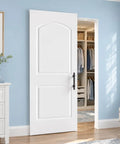 Ready To Paint White Primer Raised Two Panel Sliding Barn Door With Hella Smooth Soft Close Hardware Top Pick For Dropping Into Any Rustic Loft Or Urban Studio Upgrade in a blue room with closet.