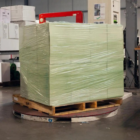 Heavy Duty Green Tint Pre Stretched Stretch Wrap Film 15 By 1476 Feet 30 Gauge 4 Roll Pack securing boxes on a wooden pallet.