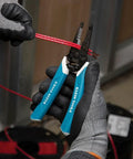Hand using Pro Grade Wire Stripper And Cutter For 8 To 18 AWG Solid And 10 To 20 AWG Stranded Wire With Six Precision Ground Stripping Holes Narrow Head For Tight Corners Made In USA Durable Hand Tool For DIY And Pros on red wire