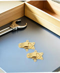 Cool Vintage Duckbill Hasp Latches For Secure Wooden Boxes And Storage Lockers on a workspace with tools.
